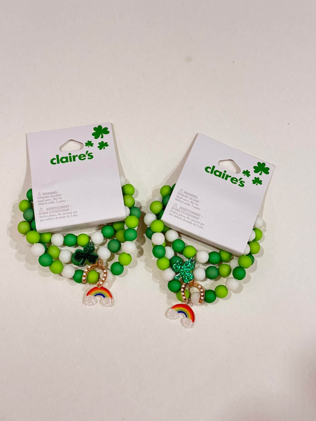 Claire’s green and white good luck charm bracelet set with rainbow horseshoe and shamrock charm